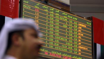 An Emirati man follows the market's movement on a monitor at the Dubai Financial Market (Karim Sahib/AFP/Getty Images)